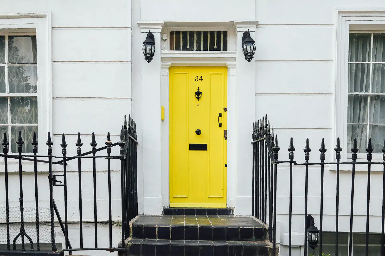 Conservation area windows in Newcastle upon Tyne Yellow panelled front door on a Georgian-style brick terrace, illustrating conservation area windows for homes in Newcastle upon Tyne