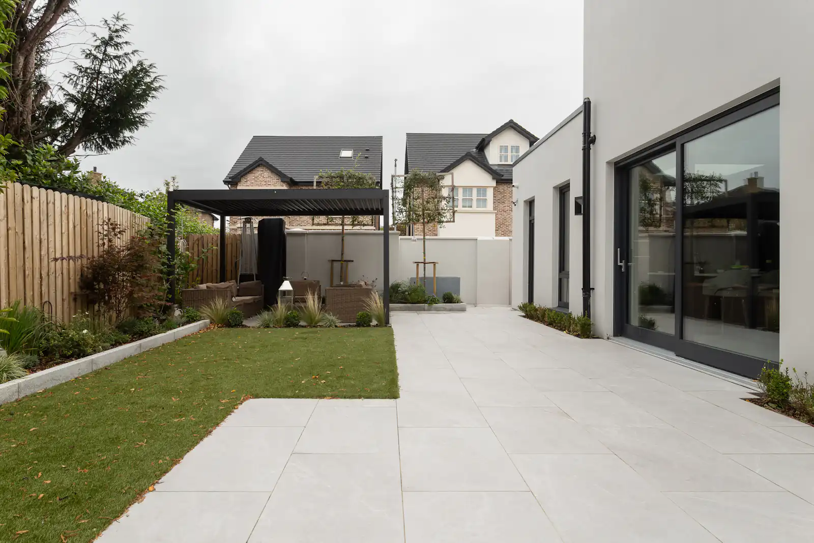 Modern rear extension with a solid roof, large glazed doors and a patio garden, illustrating replacement conservatory roofs for homes in Newcastle upon Tyne