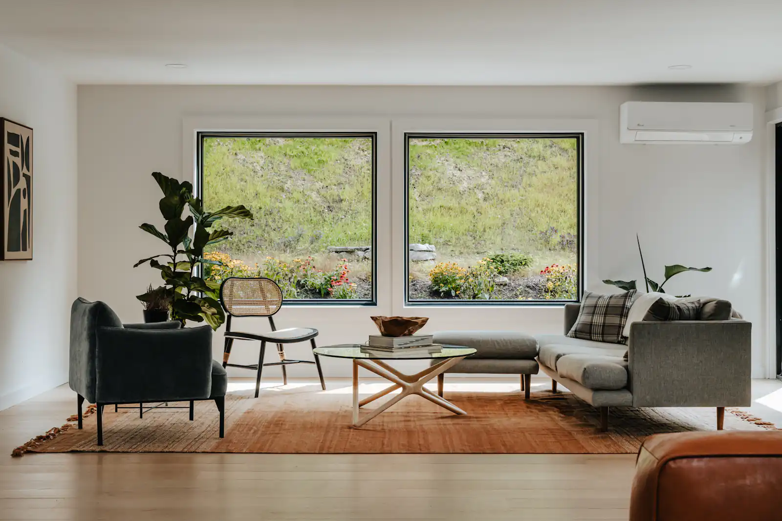 Replacement windows in Newcastle upon Tyne Bright living room with large windows looking out onto trees, illustrating replacement windows for homes in Newcastle upon Tyne