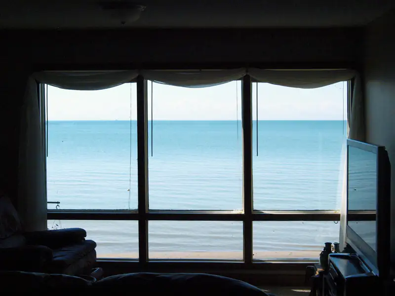 Calm sea view through a large window, illustrating triple glazing for homes in Newcastle upon Tyne