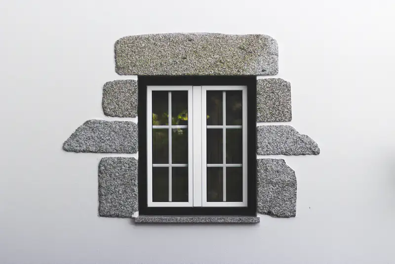 Small white casement window set in a stone surround, illustrating window & door repairs for homes in Newcastle upon Tyne