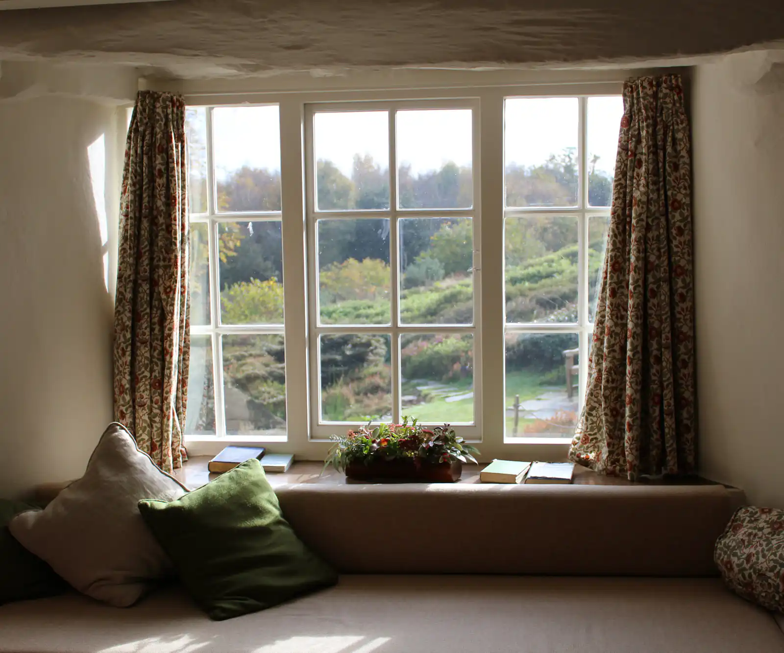 Living room with a large picture window looking out over green fields, illustrating windows and doors for homes in Newcastle upon Tyne